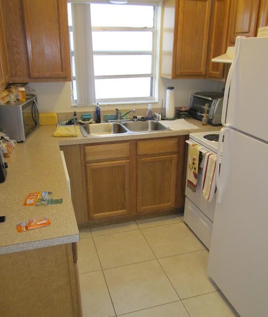 The kitchen in this two-bedroom rental has a dishwasher, double stainless steel sink, stove, and refrigerator. 