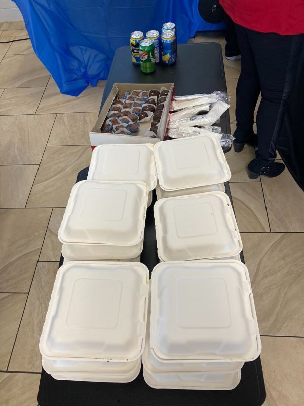 Styrofoam boxed lunchs on a table ready for distribution. 
