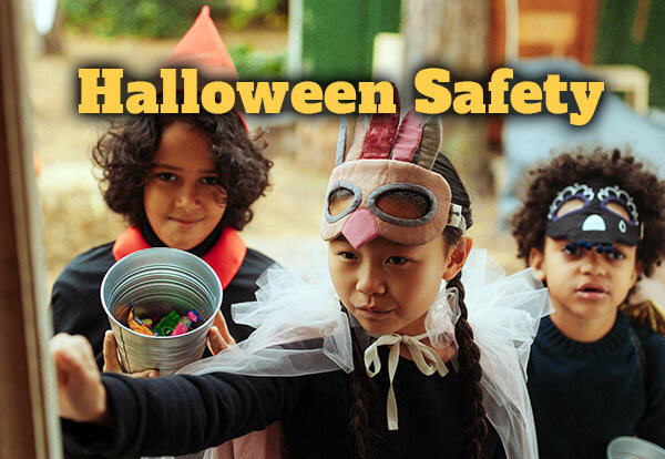 Three children trick or treating at a door with the text Halloween Safety.