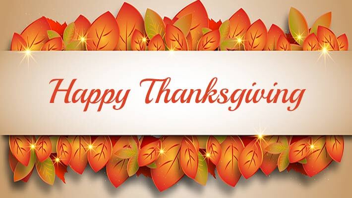 Fall leaves behind a banner with the text HappyThanksgiving.