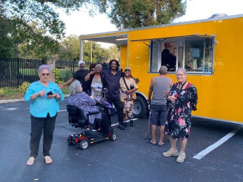 Residents gathered next to a Food Truck.